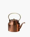 Copper tea kettle with a shiny finish and a curved spout. It features a round, gold-colored handle and lid, reflecting a classic, elegant design. | SW Home