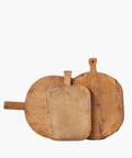 Three rustic, wooden cutting boards of varying shapes and sizes overlap. Their worn texture suggests frequent use, conveying a homely, vintage feel. | SW Home