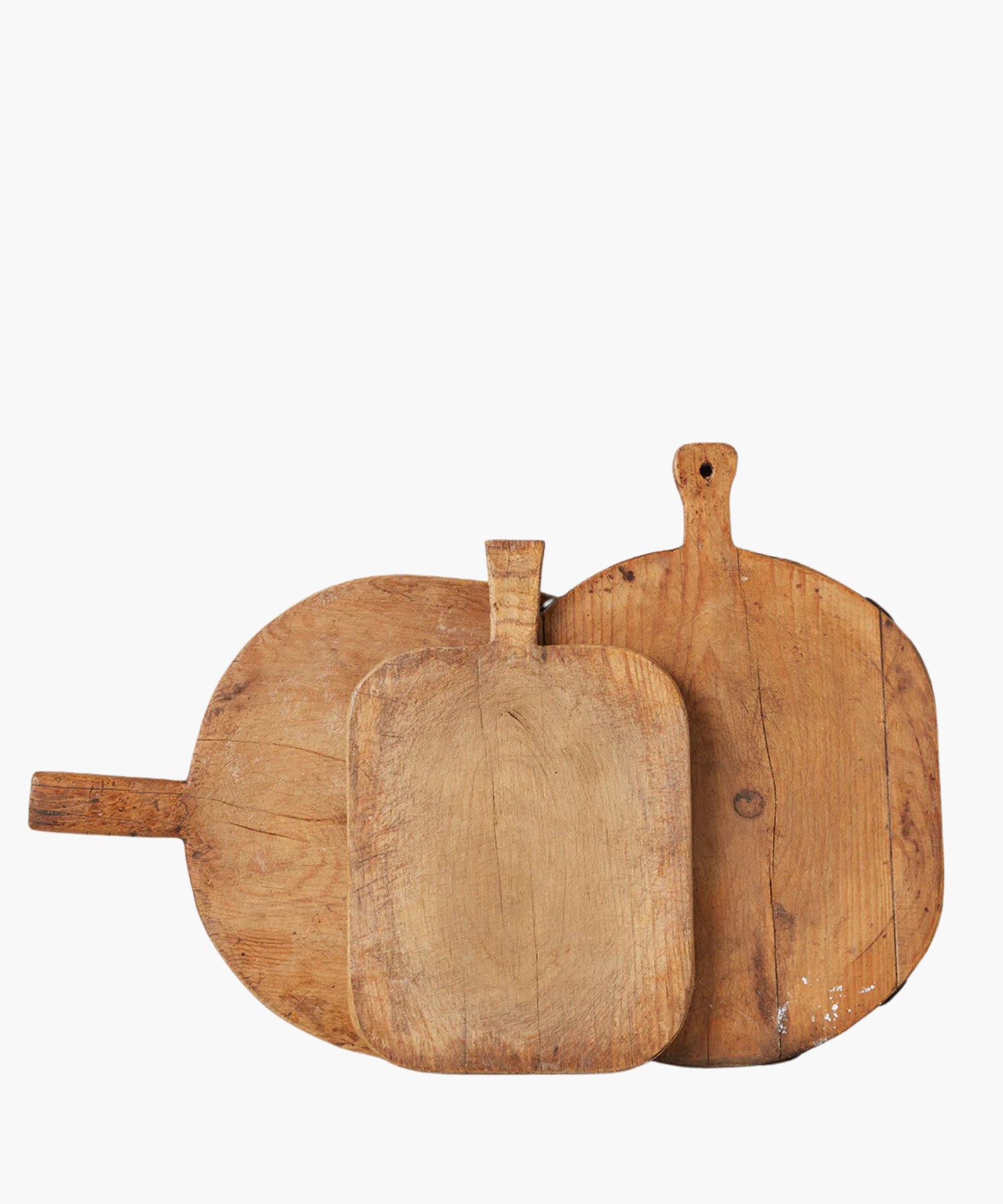 Three rustic, wooden cutting boards of varying shapes and sizes overlap. Their worn texture suggests frequent use, conveying a homely, vintage feel. | SW Home