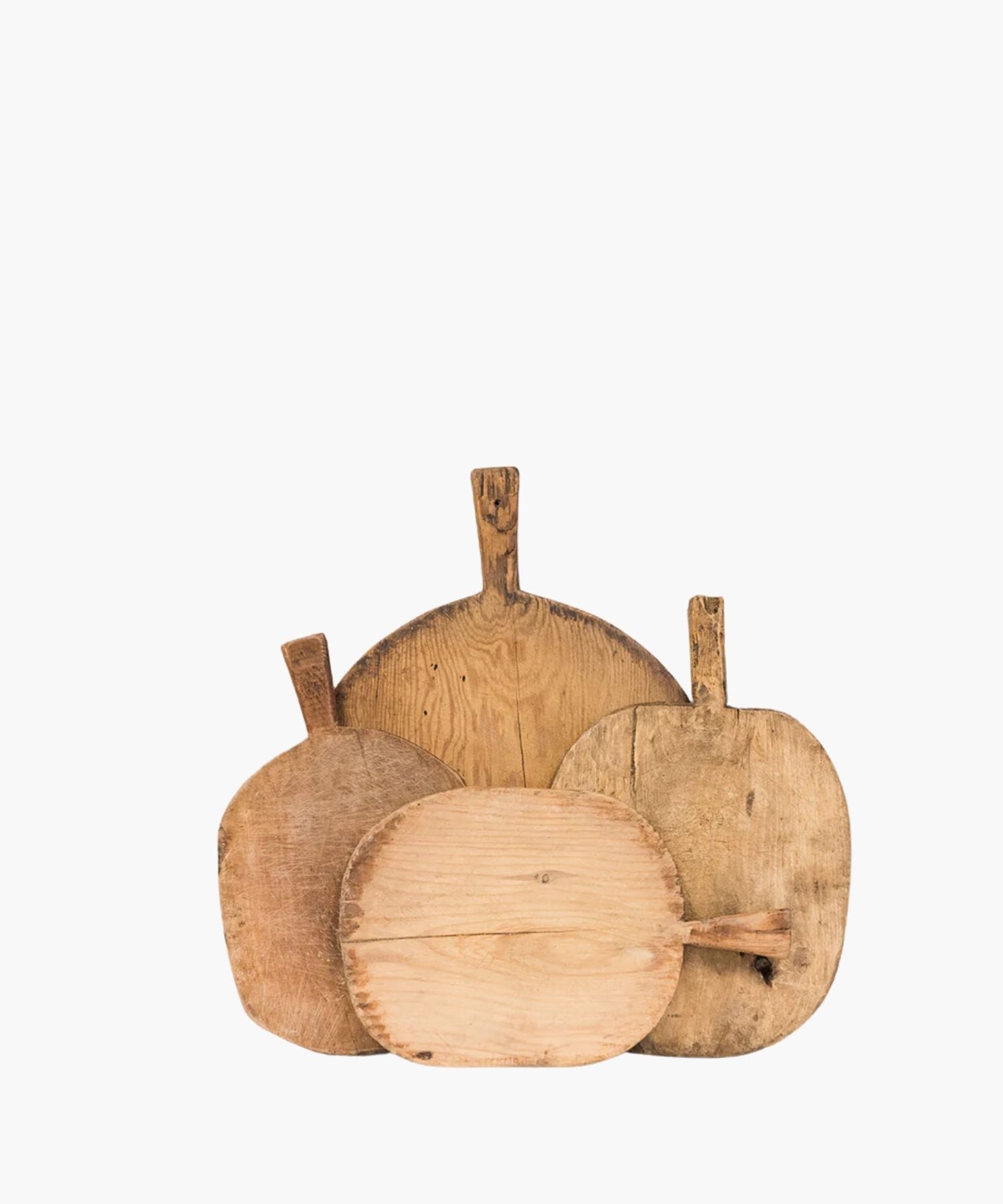 Four rustic, wooden cutting boards of varying shapes and sizes overlap. Their worn texture suggests frequent use, conveying a homely, vintage feel. | SW Home