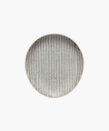 Round ceramic spoon rest with a diagonal blue herringbone pattern on a white background. The design is symmetrical, creating an elegant, minimalist look. | Wildwood Home Co.
