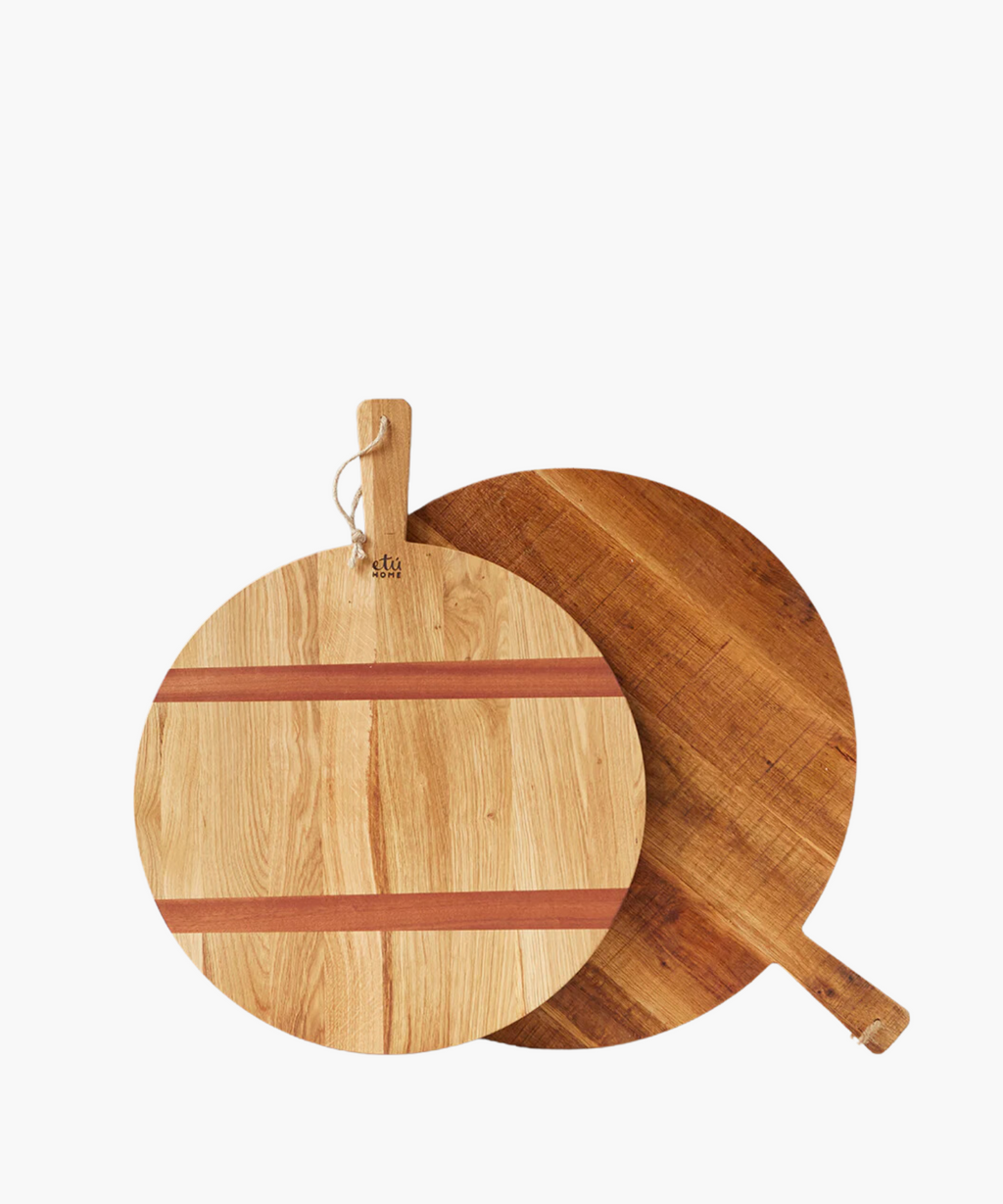 Two round wood cutting boards overlap on a white background, featuring natural wood grain and handles with hanging loops, conveying a rustic kitchen feel. | SW Home