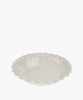 Ceramic serving bowl with a glossy, white finish, featuring a ruffled edge. The dish is empty and sits on a plain white background. | SW Home