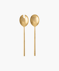 Two elegant, matte gold salad servers on a white background. One has a forked design, the other a smooth, rounded bowl. Minimalist and luxurious tone. | Wildwood Home Co.