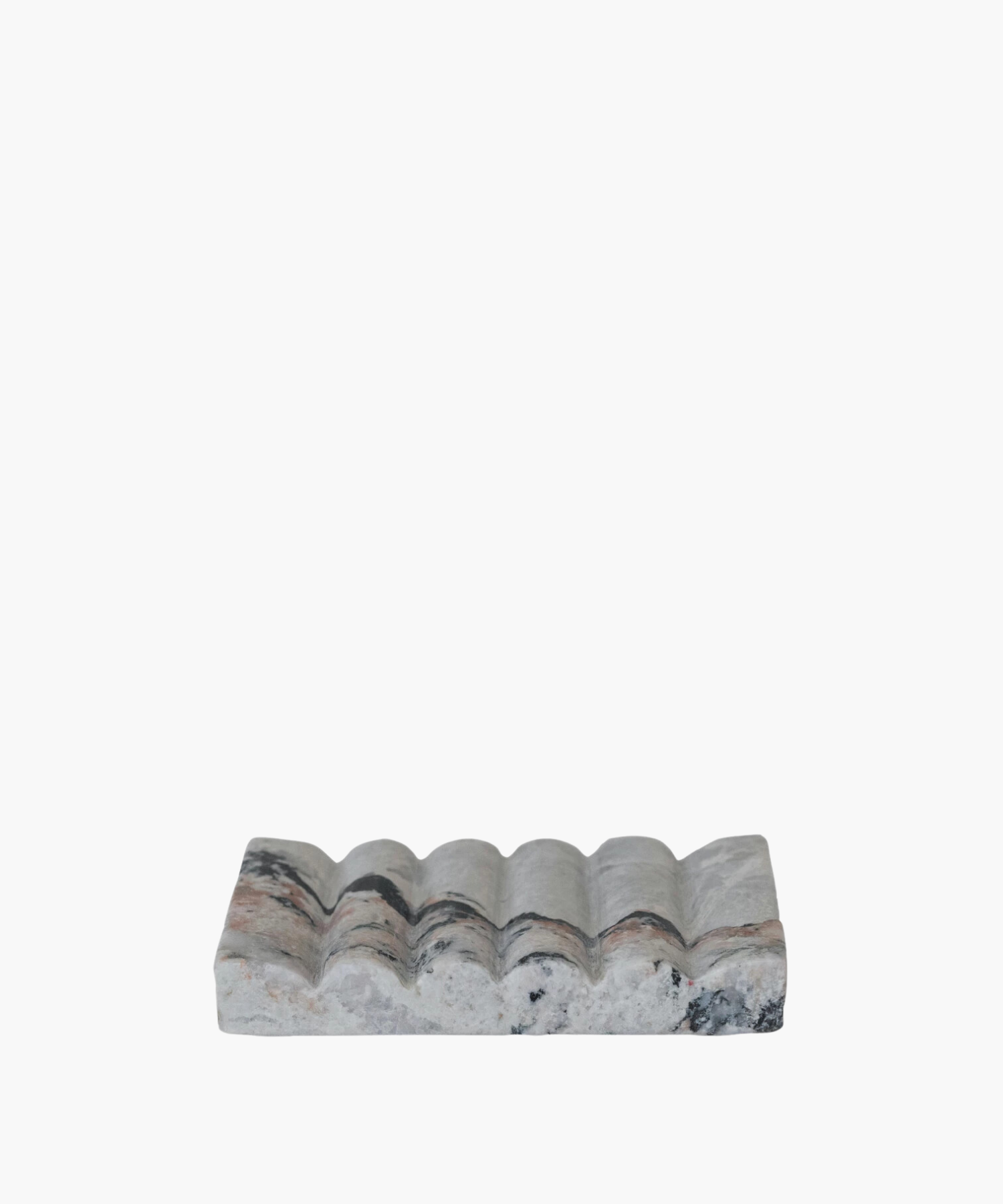 A rectangular marble soap dish with a wavy, textured surface. The stone features gray, black, and pink veins, conveying an elegant and natural aesthetic. | Wildwood Home Co.