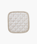 Quilted pot holder with a beige and white checkered pattern, framed by a light brown border. It has a soft, textured appearance, evoking coziness. | Wildwood Home Co.